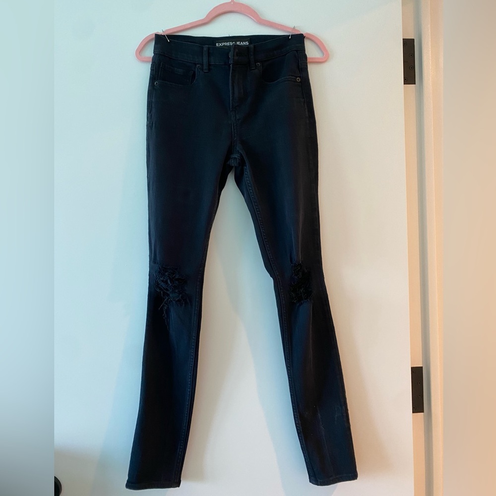 Express skinny black jeans with destroyed knees.